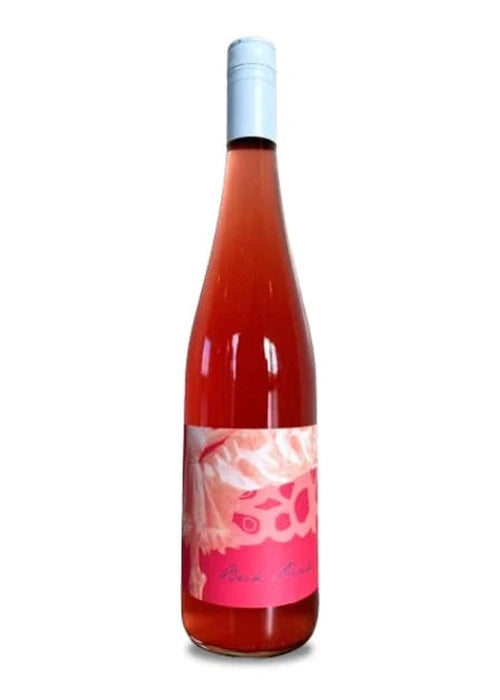 Judith Beck Pink rosé wine bottle with light pink liquid and blue screw cap