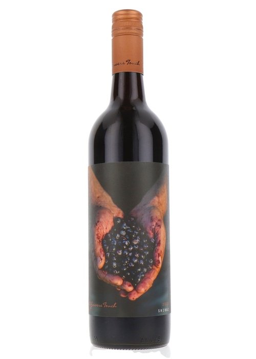 A Growers Touch Shiraz wine bottle with black label and grape hands design